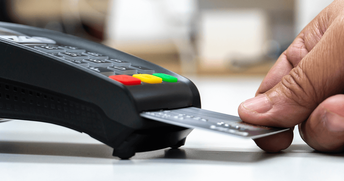 person inserts chip credit card into payment terminal