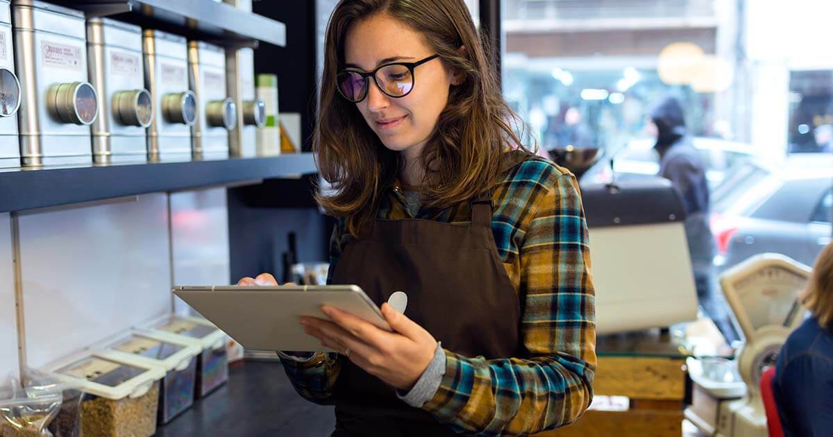 woman using a tablet in a cafe