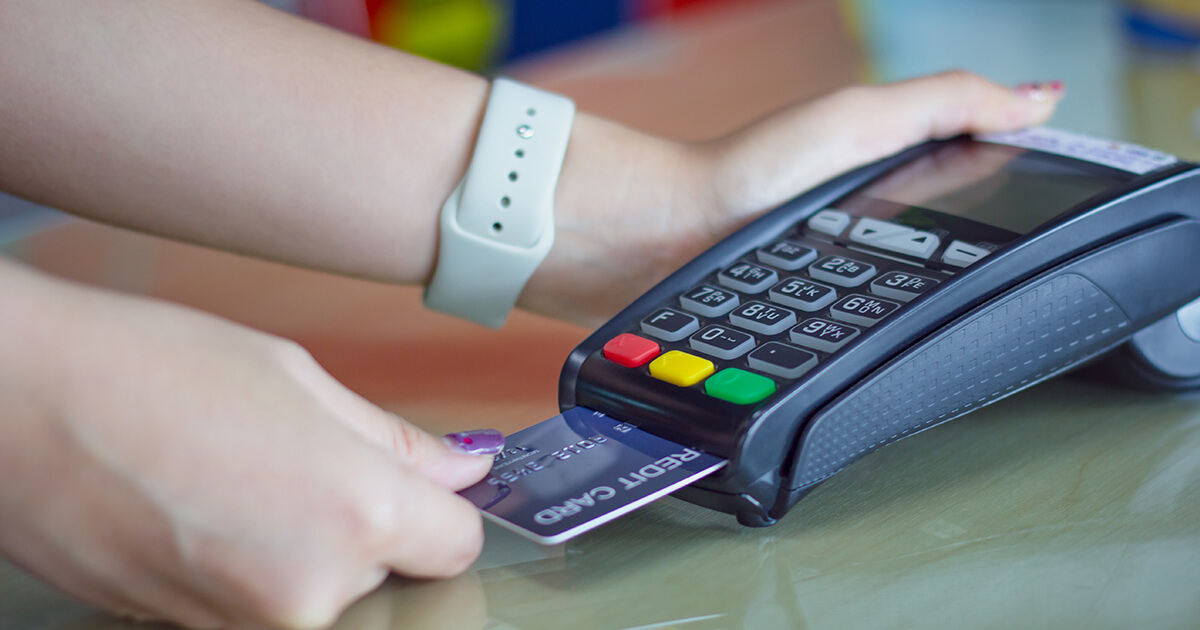 customer paying with chip credit card at payment terminal