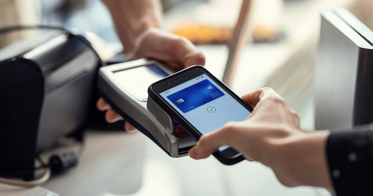 customer using contactless payment to pay with their phone