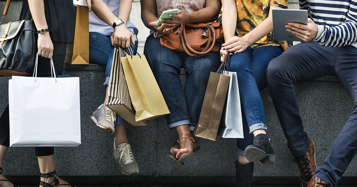 shoppers holding bags of purchases