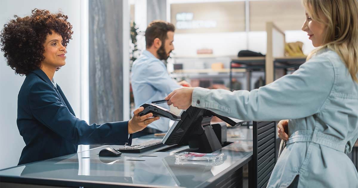 woman paying at pos system