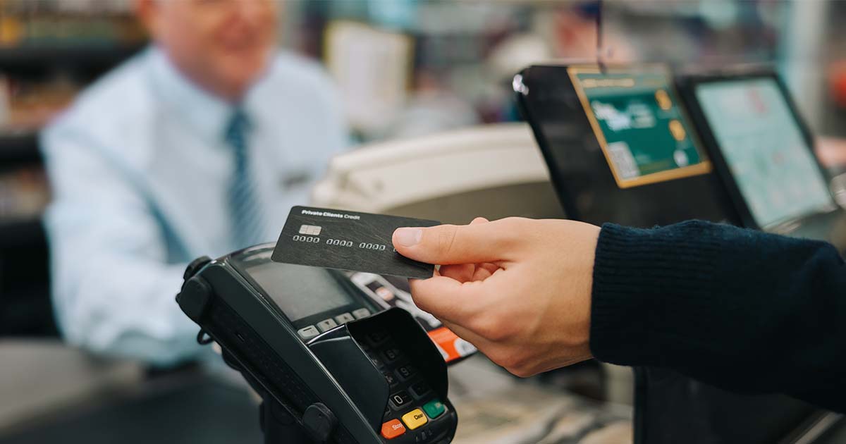 person paying with card at cash register