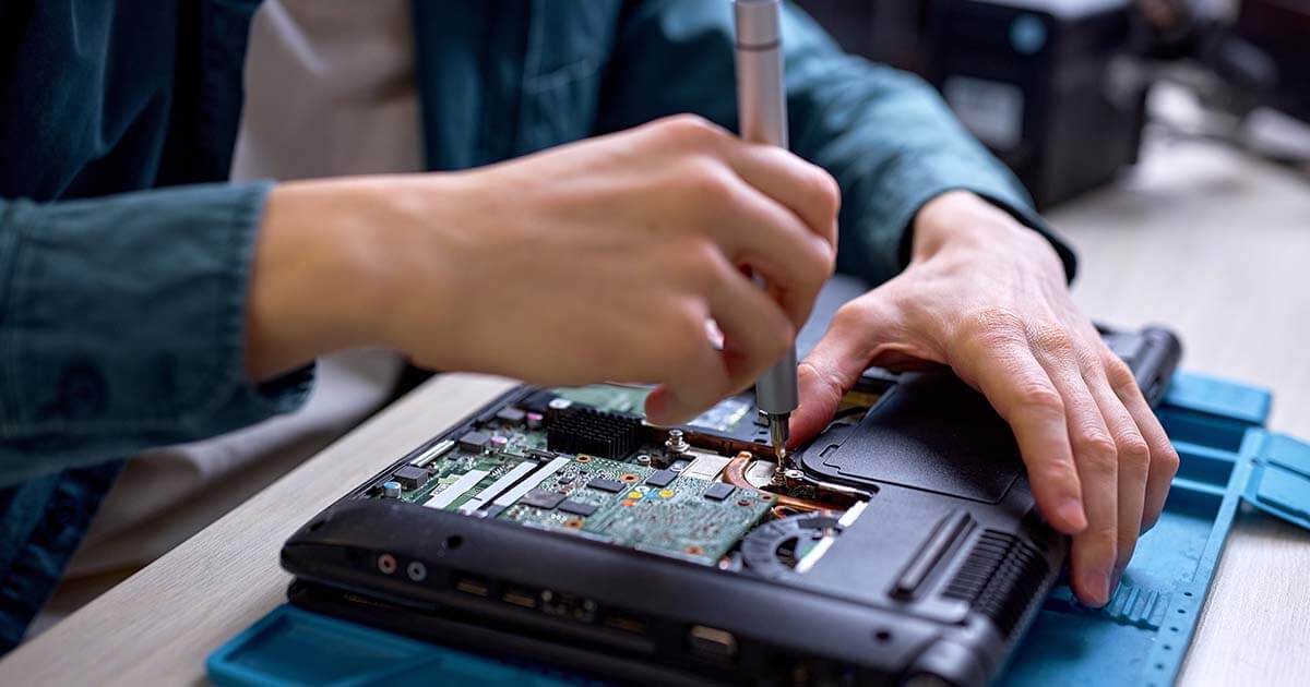 man fixing a computer