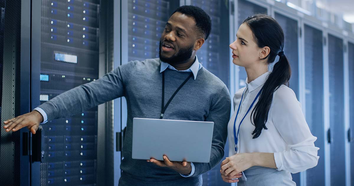 seasonal IT workers looking at server cabinet