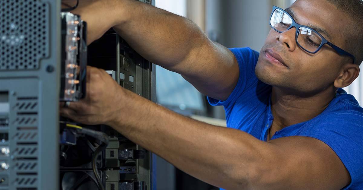 IT technician fixing computer