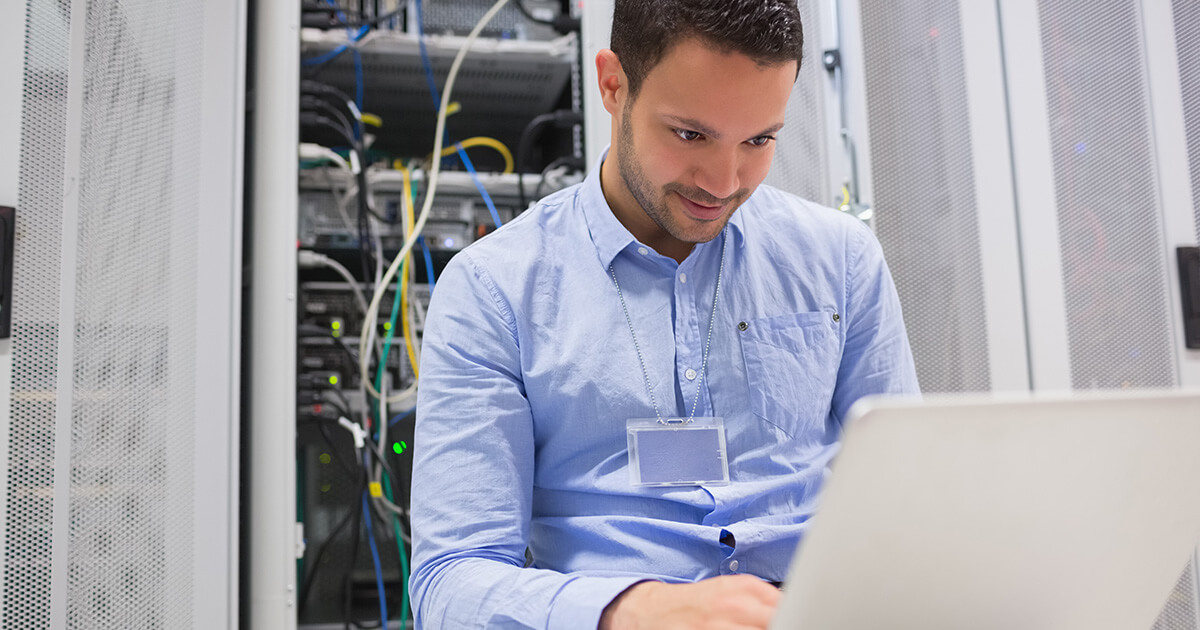 IT service worker completing a maintenance call on store technology