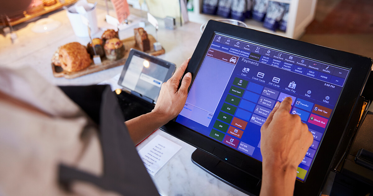 restaurant employee working at point of sale screen