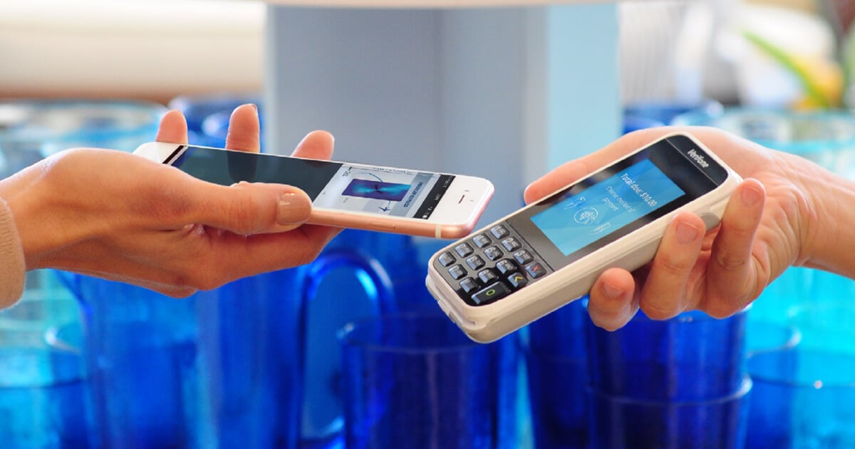 customer pays with phone at payment terminal