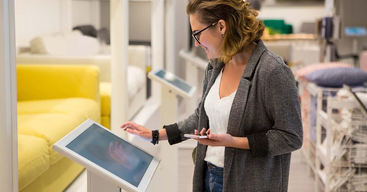 woman using self service kiosk