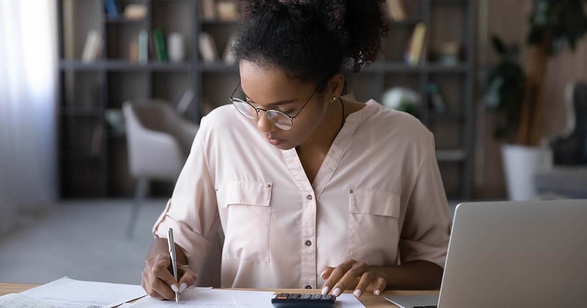 woman calculating IT hardware budget