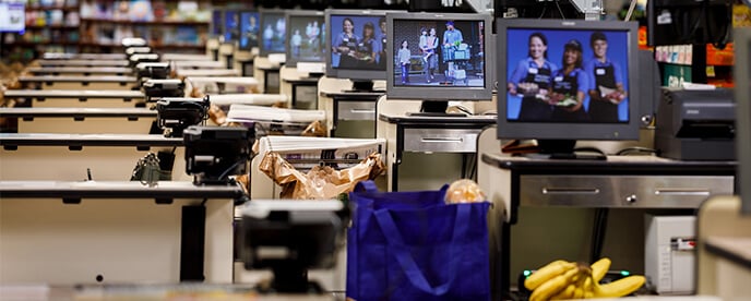 rows of point of sale systems at checkout lanes in a store