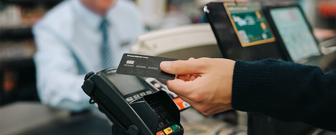 customer paying with credit card at payment terminal