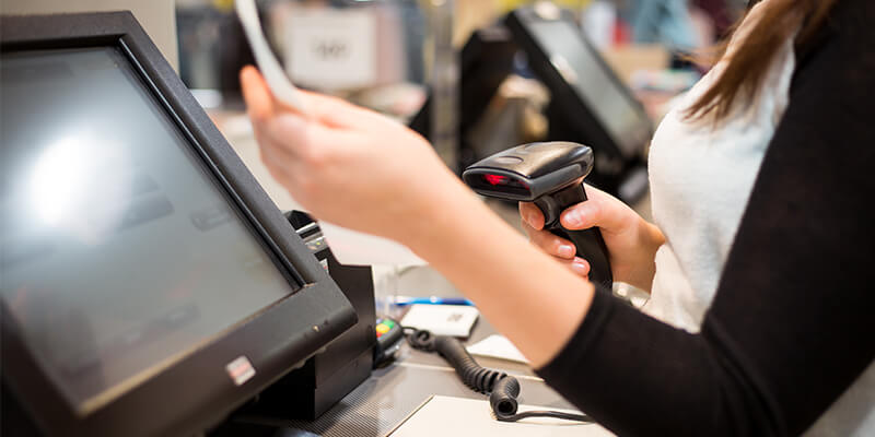 cashier scanning a receipt at the point of sale