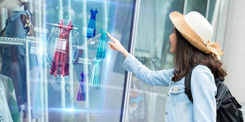 woman touching interactive kiosk display