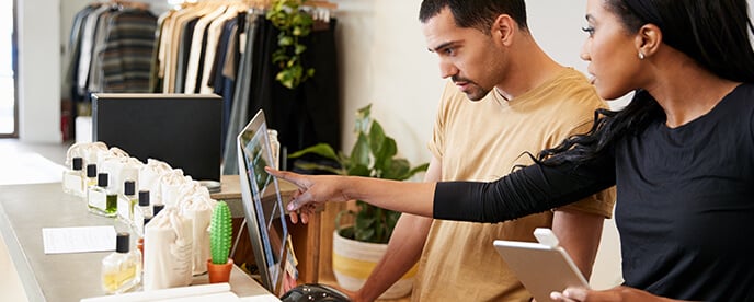 person helping employee with POS technology